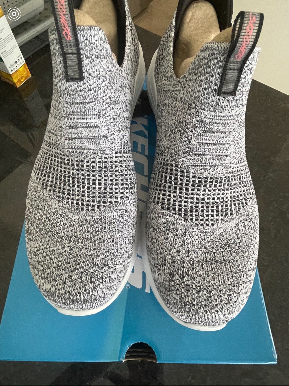 Skechers Slip-On Knit Sneakers in Black and White with Pink Logo